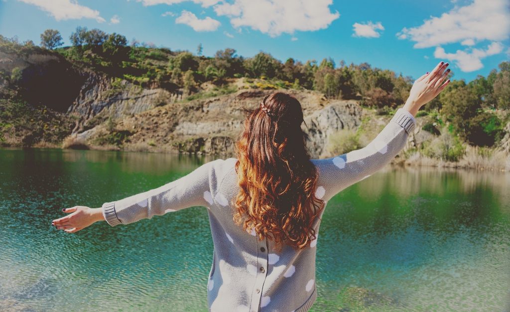 Girl standing in front of a lake