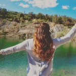 Girl standing in front of a lake