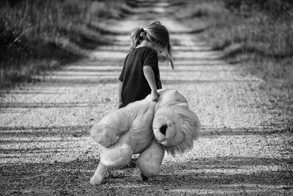 Sad girl carrying teddybear