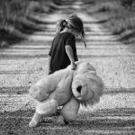 Sad girl carrying teddybear